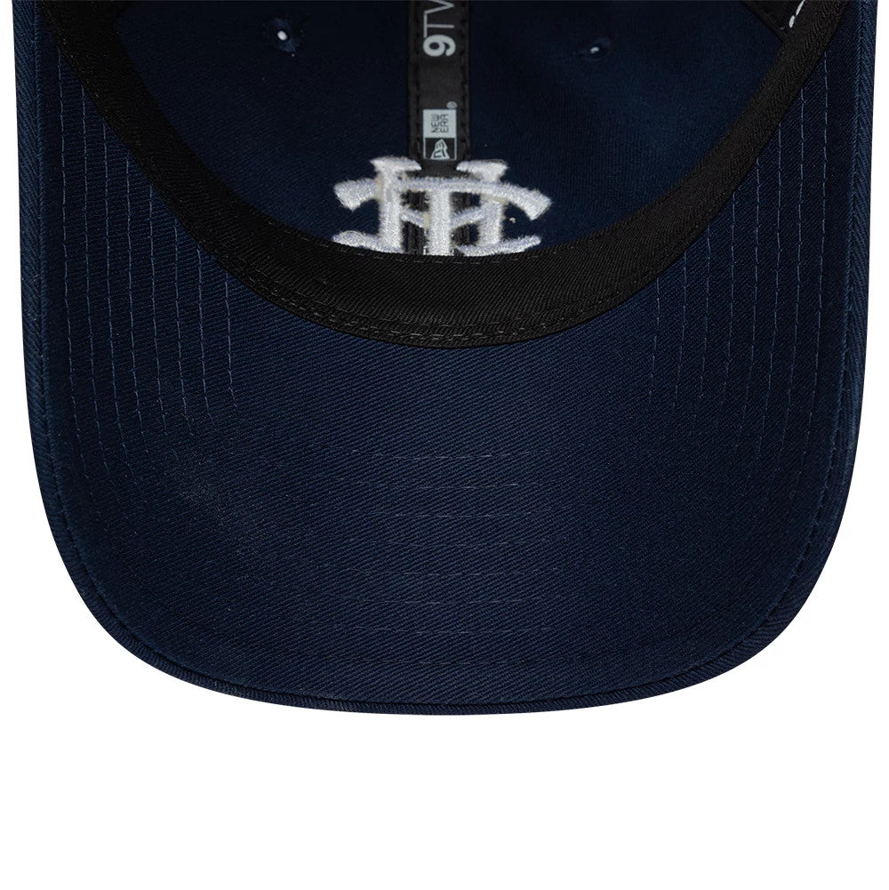 Tottenham Hotspur FC Monogram Navy New Era 9TWENTY Adjustable Cap, inside view showing a black sweatband, a grey crown seam tape running from front to back, and a white TH monogram embroidered on the navy undervisor.