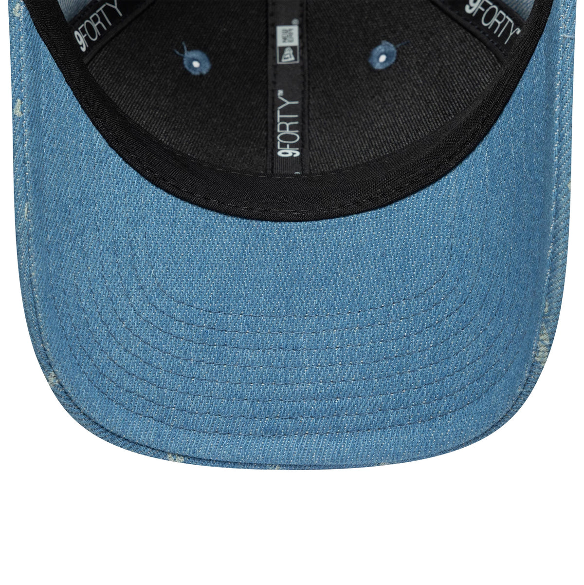 VR46 Denim Open Blue New Era 9FORTY M-Crown Cap, inside view showing 9FORTY taping along the seams, a black sweatband, and stitching on the blue denim undervisor, with eyelets in matching fabric.