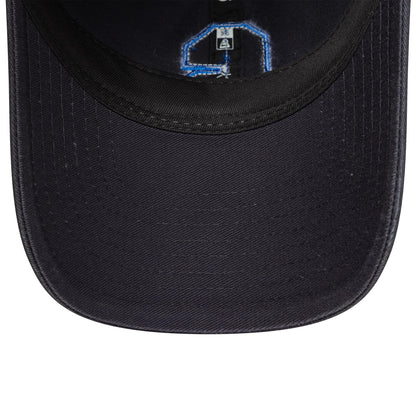 Chelsea FC Lion Crest Boucle Navy New Era 9TWENTY Cap, inside view showing the black sweatband and navy undervisor with stitched taping in blue and a size label near the crown.