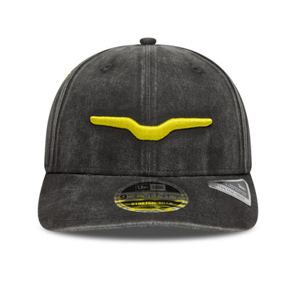 Moto Guzzi Washed Black New Era 9SEVENTY Stretch Snap Cap, front view showing a yellow embroidered logo on the front panel, with a pre-curved visor and a 9SEVENTY size sticker on top.