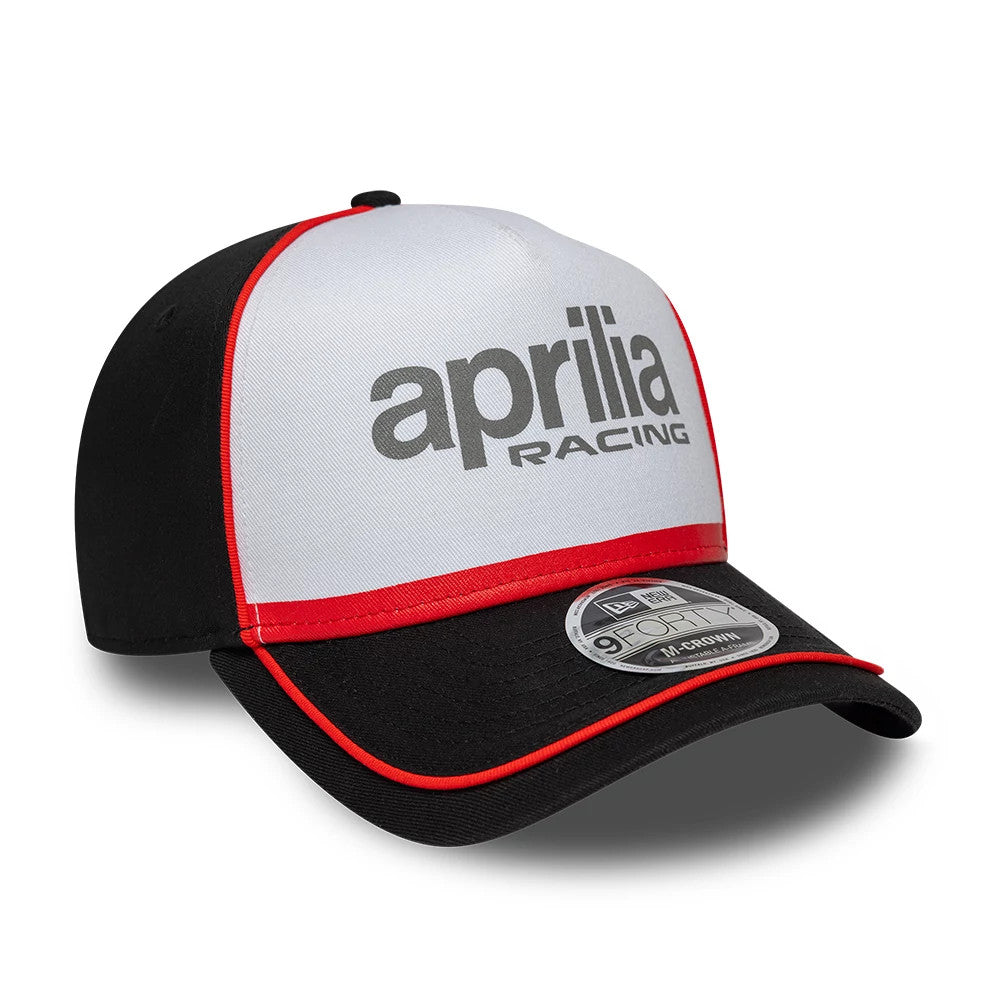 Aprilia Reflective Black New Era 9FORTY M-Crown A-Frame Cap, three-quarter view showing the grey aprilia racing logo in raised embroidery on the white front panel, with a black visor and a 9FORTY size sticker.