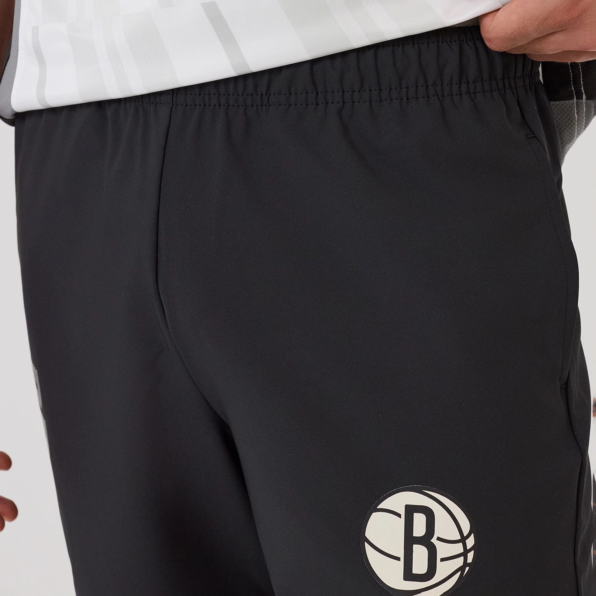 The model is wearing this NBA Match Brooklyn Nets Oversized Shorts in black. 6
