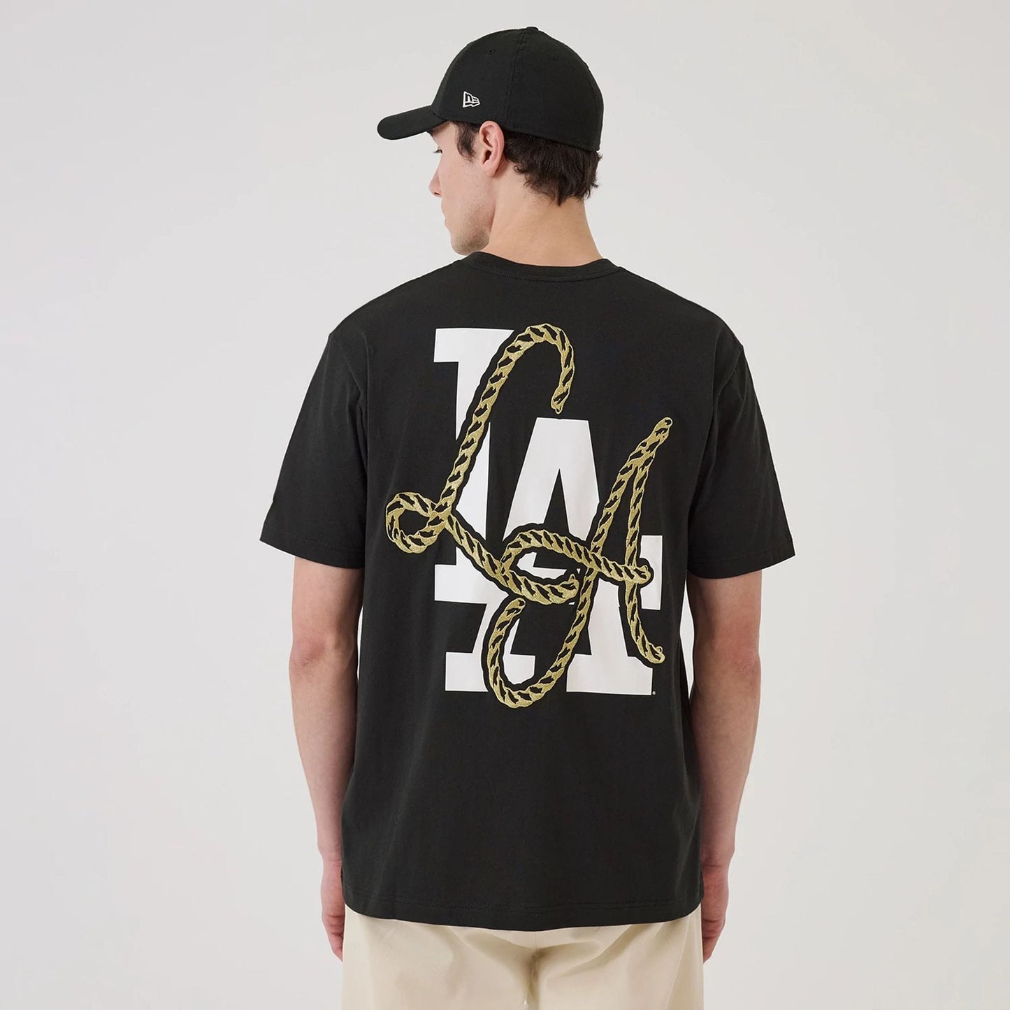 The model is wearing this MLB Cowboy Graphic LA Dodgers T-Shirt in black. 2