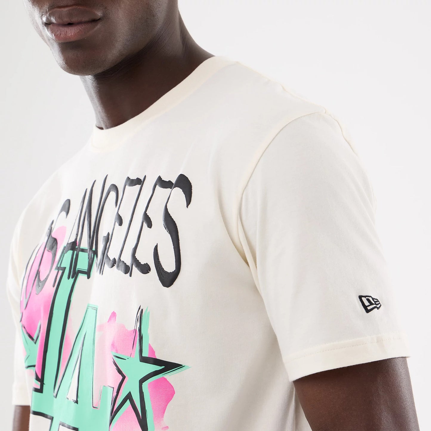 The model is wearing this MLB Street Art Graphic LA Dodgers T-Shirt in light beige. 5