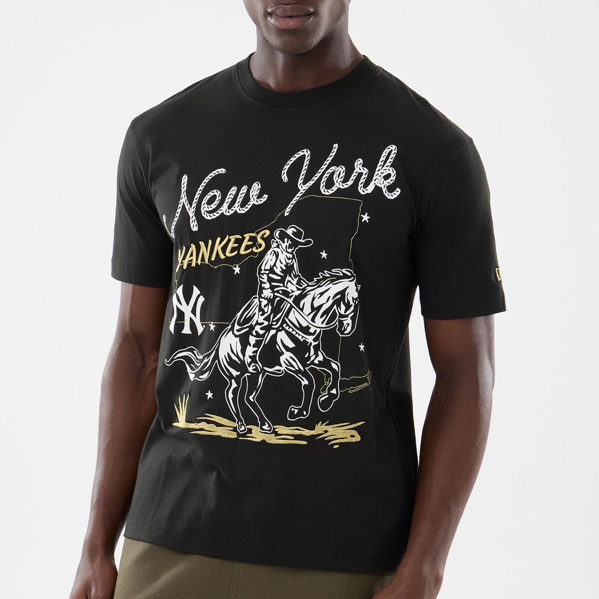 The model is wearing this MLB Cowboy Graphic New York Yankees T-Shirt in black. 1