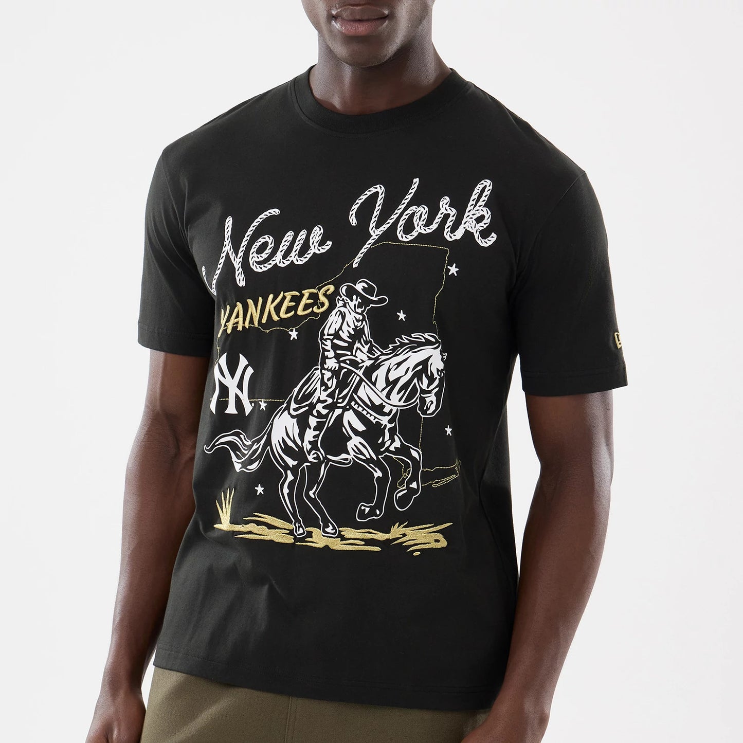 The model is wearing this MLB Cowboy Graphic New York Yankees T-Shirt in black. 3