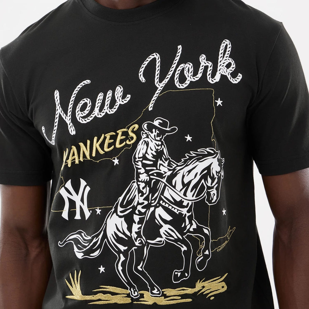 The model is wearing this MLB Cowboy Graphic New York Yankees T-Shirt in black. 4