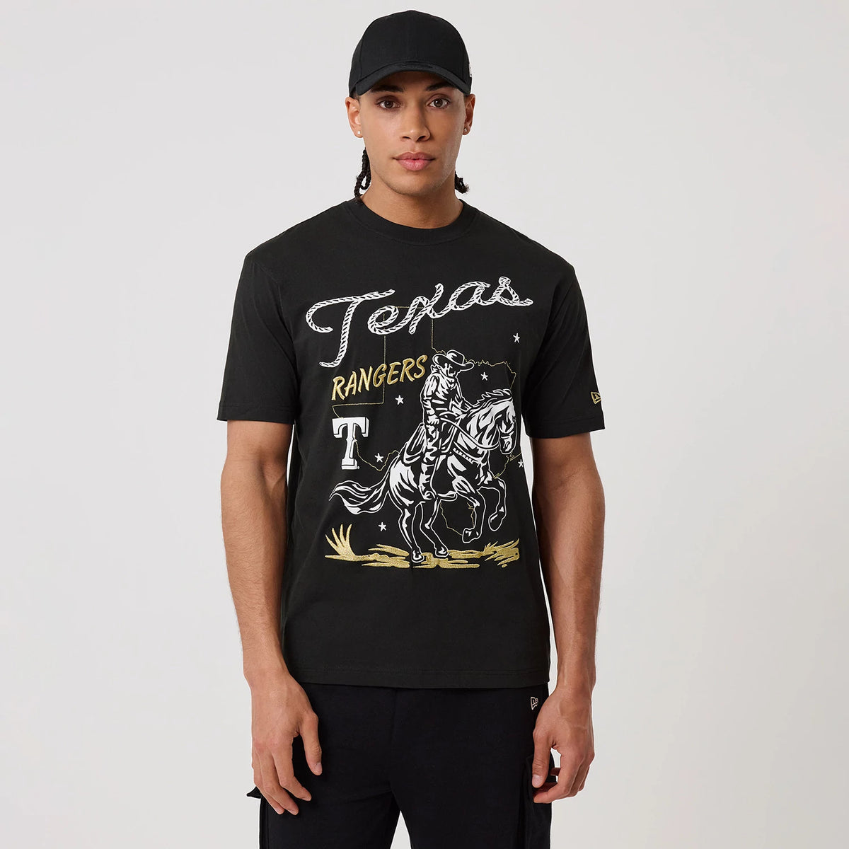 The model is wearing this MLB Cowboy Graphic Texas Rangers T-Shirt in black. 1