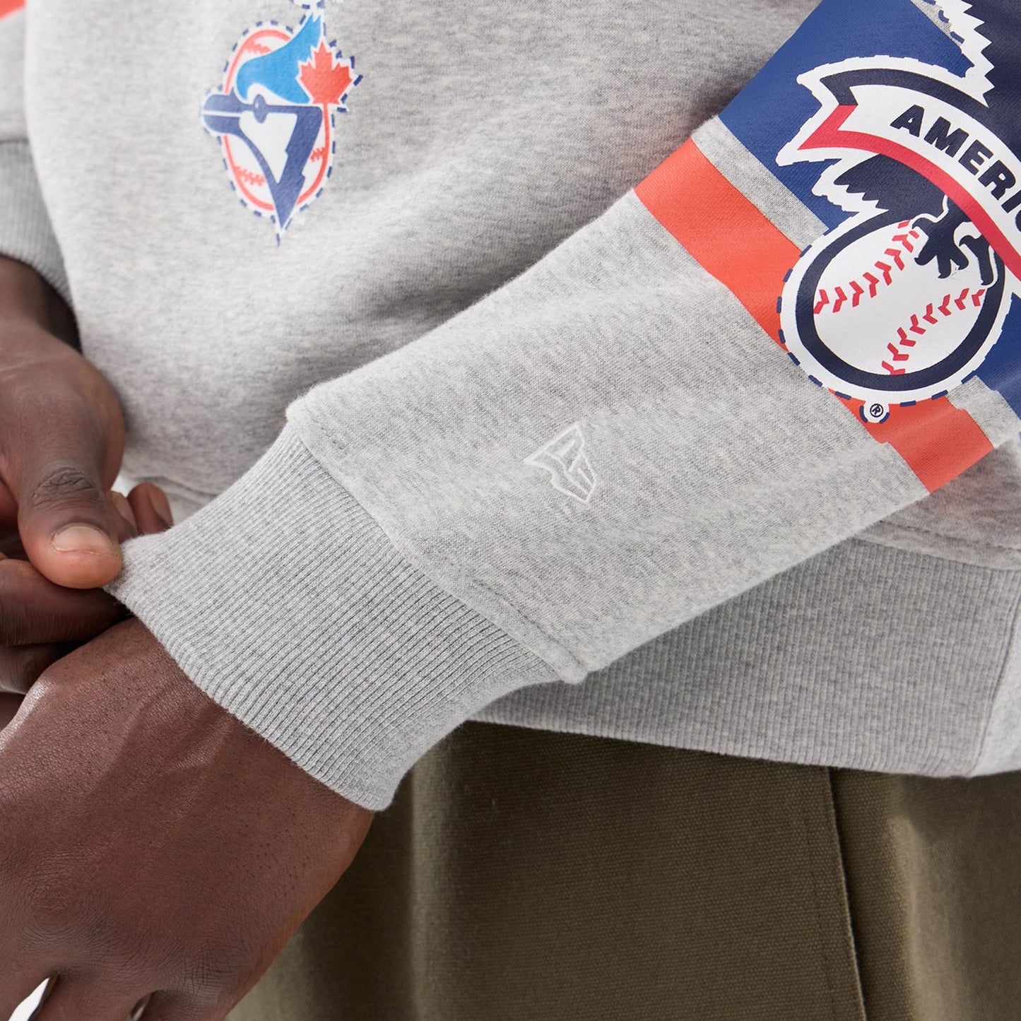 The model is wearing this MLB Sport Classic Toronto Blue Jays Crew Neck Sweater in grey. 3