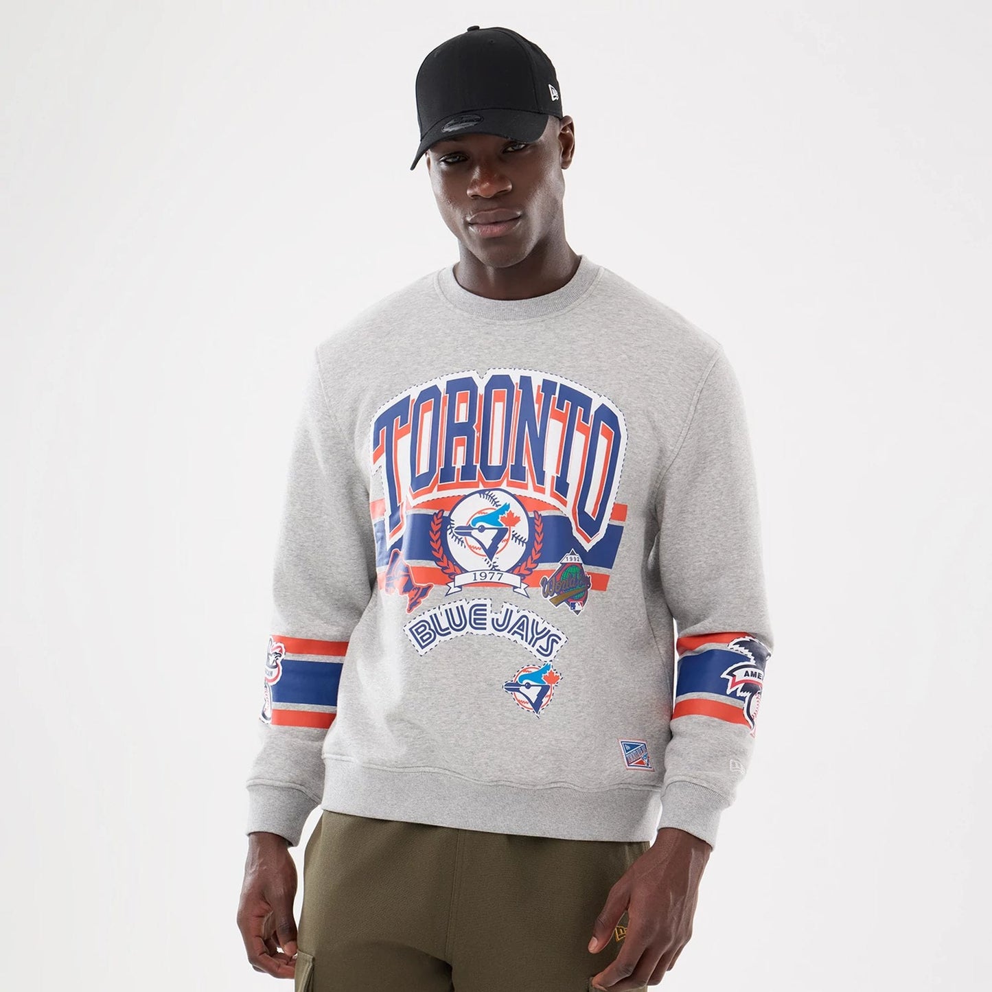The model is wearing this MLB Sport Classic Toronto Blue Jays Crew Neck Sweater in grey. 1