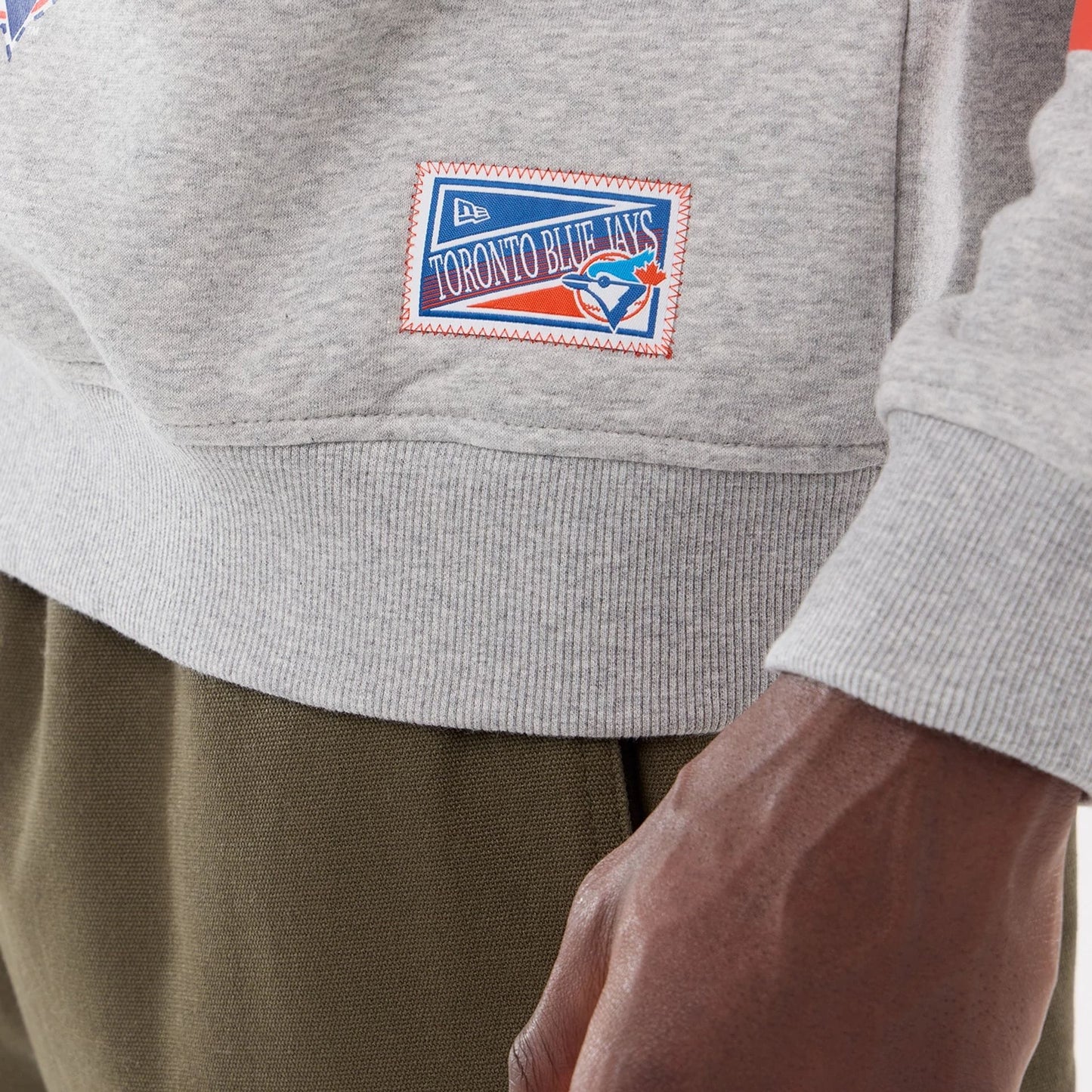 The model is wearing this MLB Sport Classic Toronto Blue Jays Crew Neck Sweater in grey. 4