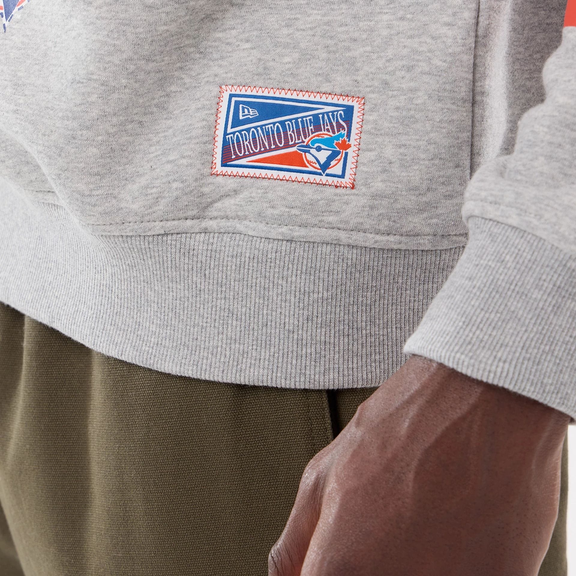 The model is wearing this MLB Sport Classic Toronto Blue Jays Crew Neck Sweater in grey. 4