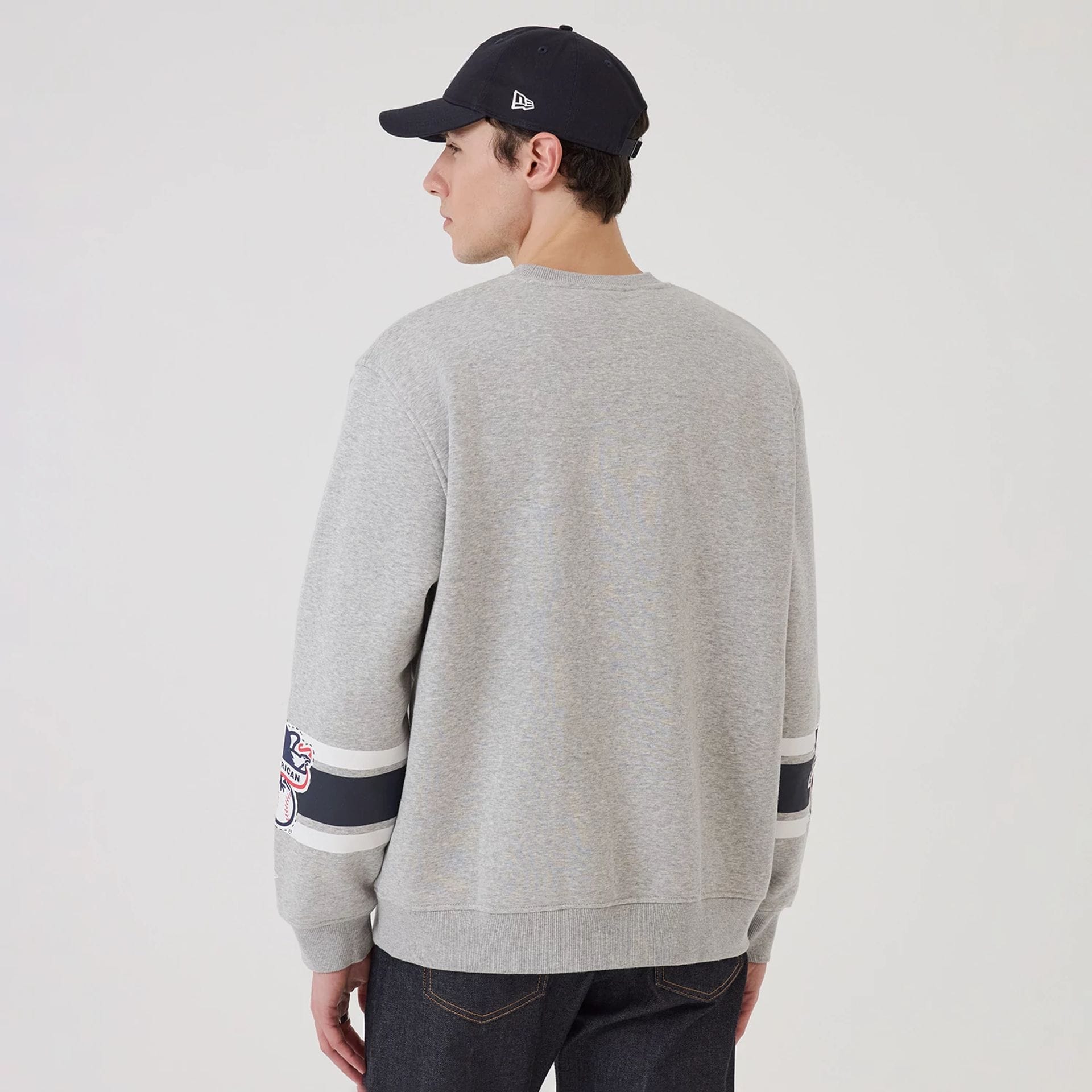 The model is wearing this MLB Sport Classic New York Yankees Crew Neck Sweater in grey. 2