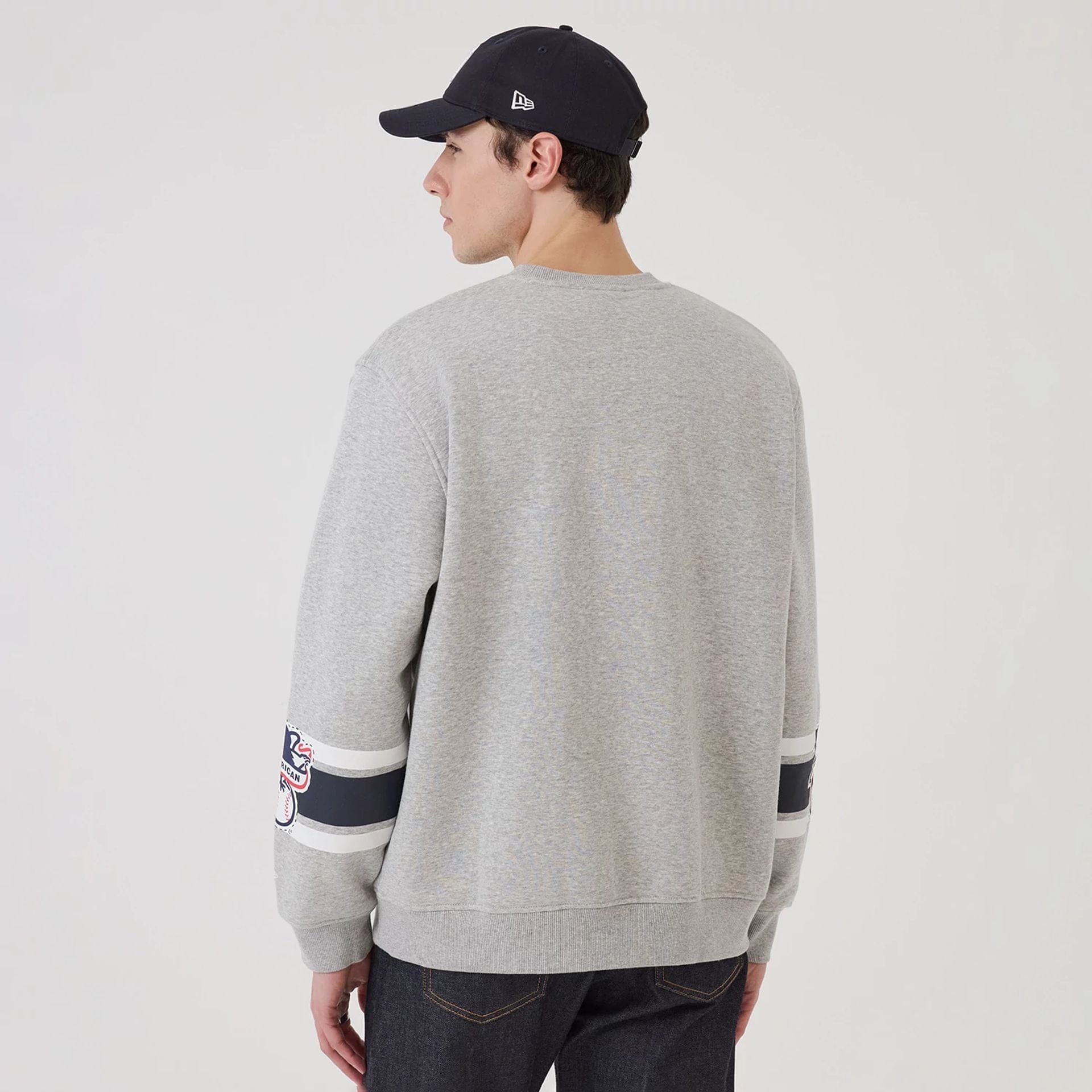 The model is wearing this MLB Sport Classic New York Yankees Crew Neck Sweater in grey. 2