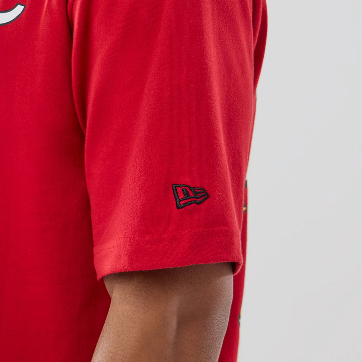New Era Kansas City Chiefs NFL Graphic Red T-Shirt, side view showing the red sleeve with a black embroidered New Era logo near the hem and part of a graphic design on the main body of the T-shirt.