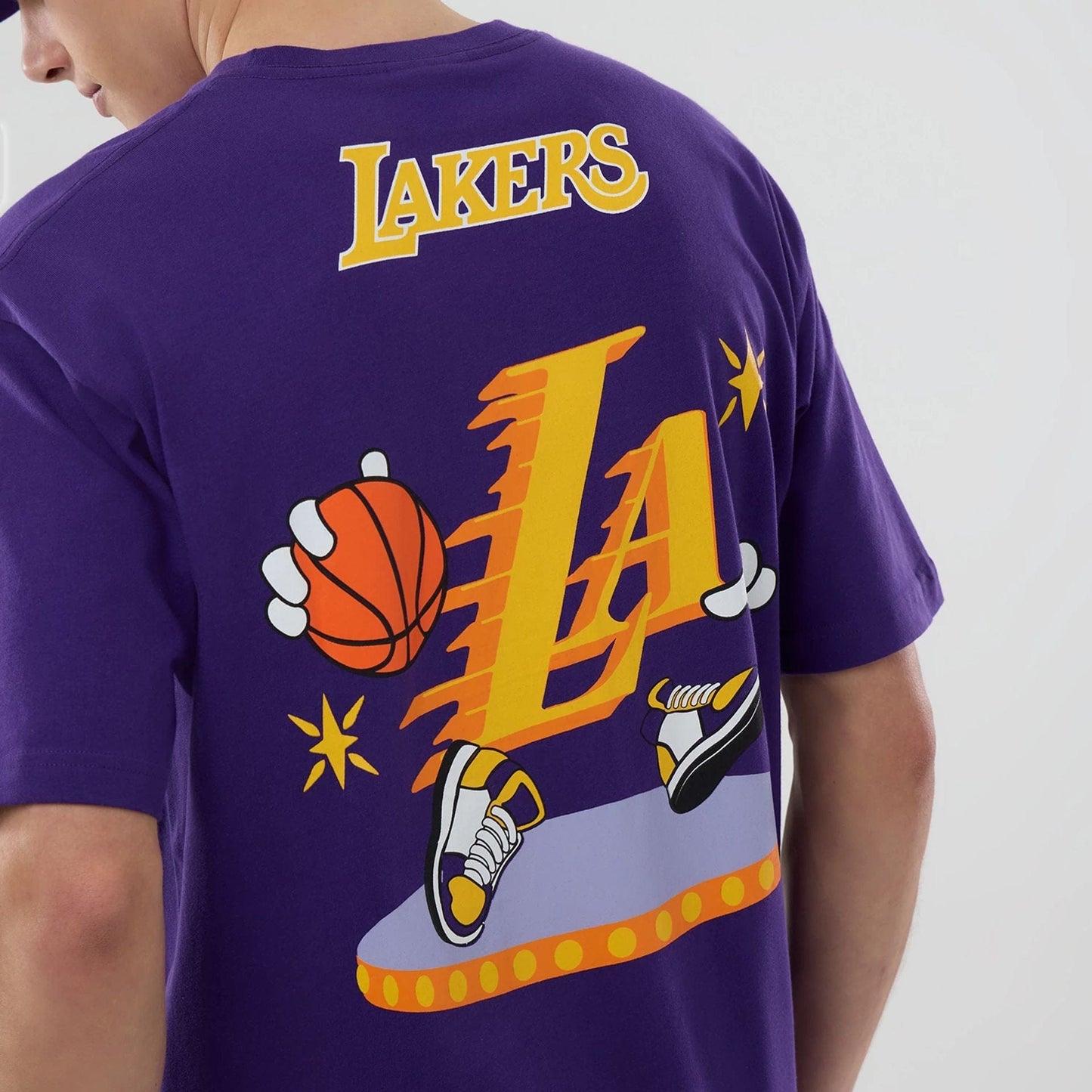 The model is wearing this NBA Graphic LA Lakers T-Shirt in purple. 3