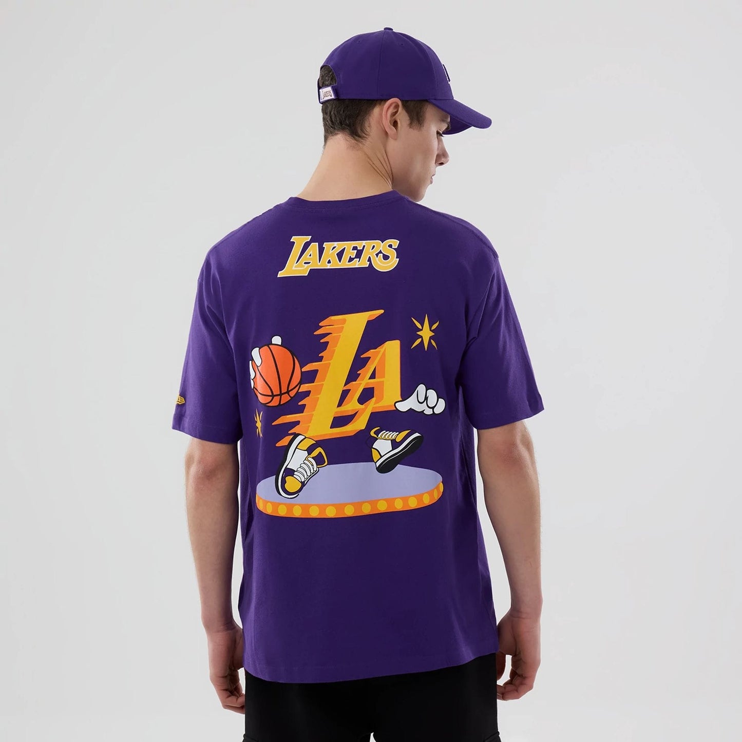 The model is wearing this NBA Graphic LA Lakers T-Shirt in purple. 2