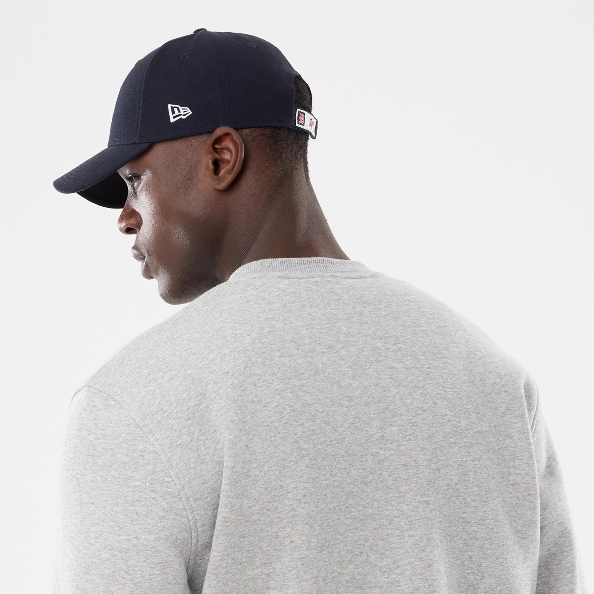 The model is wearing this MLB Sport Classic Detroit Tigers Crew Neck Sweater in grey. 5