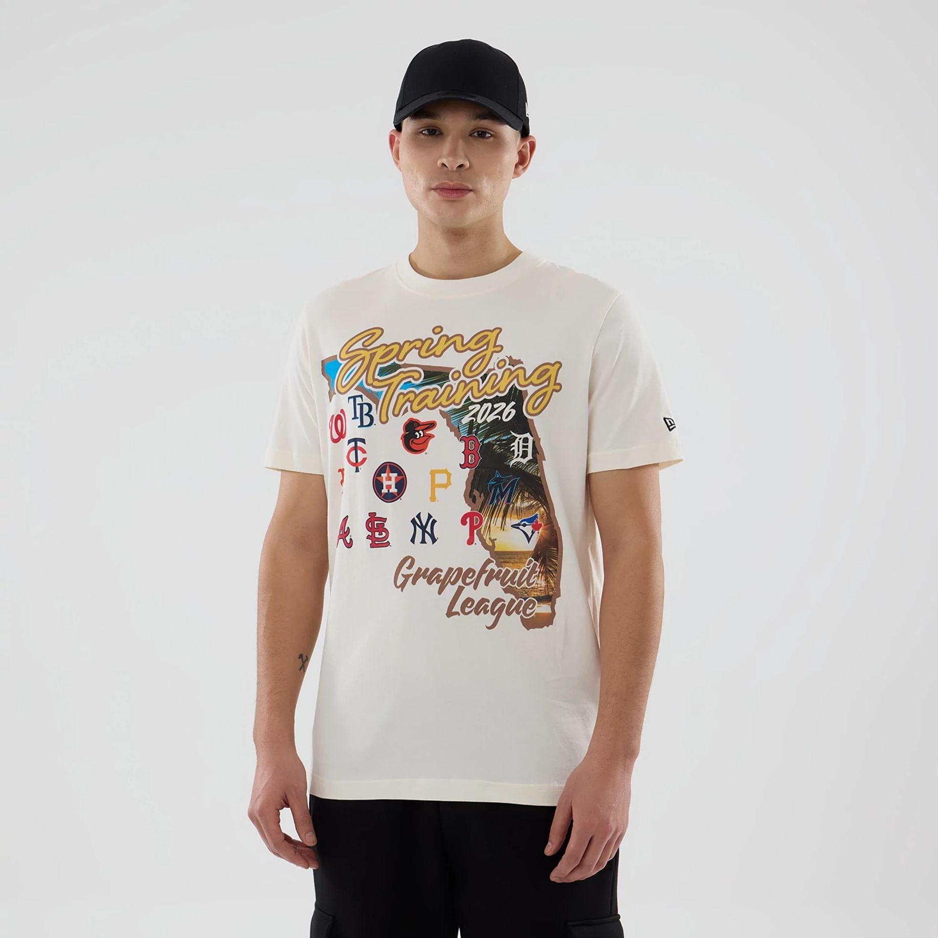 The model is wearing this MLB Spring Training 2026 Grapefruit League Logo T-Shirt in Cream. 1