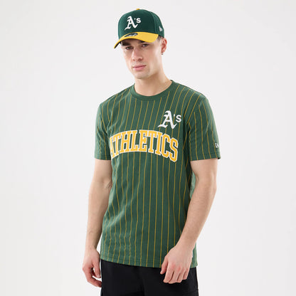 New Era Athletics MLB Pinstripe Dark Green T-Shirt, front view on-model showing the yellow pinstripes on a dark green base, white embroidered A's logo on the chest, and large yellow ATHLETICS lettering across the front.