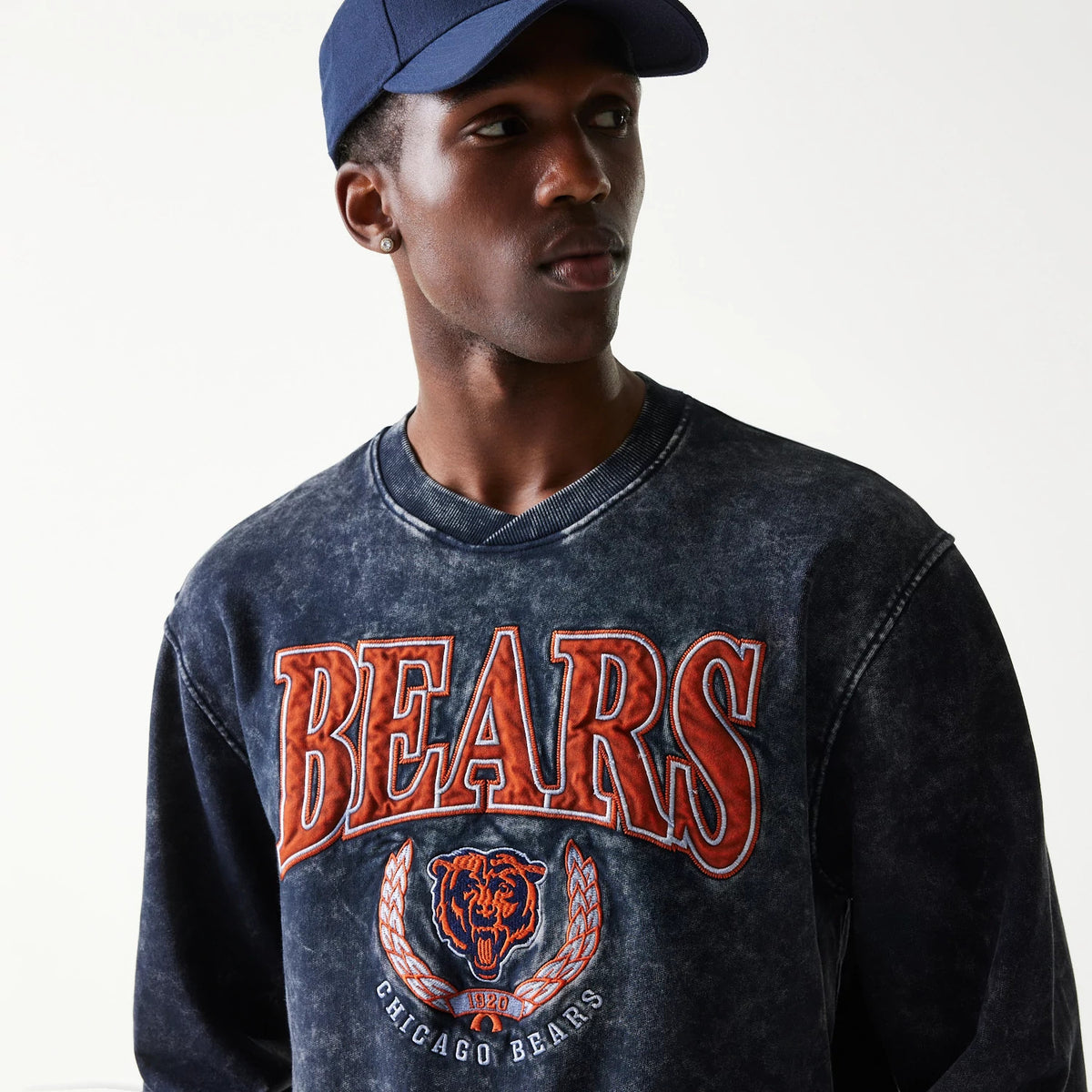 The model is wearing this NFL Chicago Bears Crew Neck Sweater in navy. 4