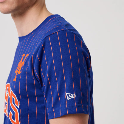 New Era New York Mets MLB Pinstripe Blue T-Shirt, three-quarter view showing blue fabric with orange pinstripes, an orange M logo on the chest, and a white embroidered New Era logo on the sleeve above the cuff.