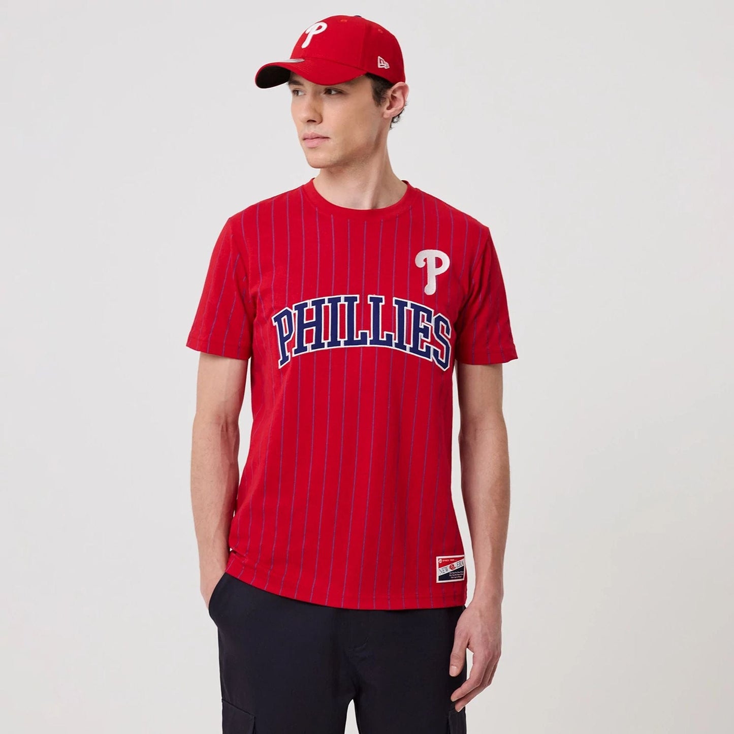 The model is wearing this MLB Pinstripe Philadelphia Phillies T-Shirt in red. 1