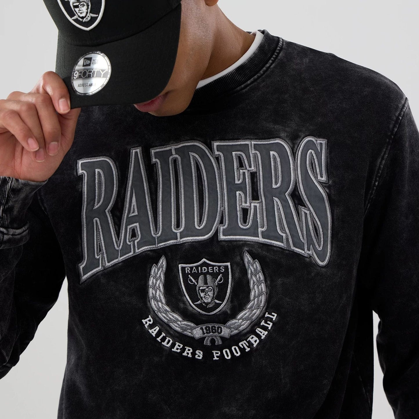 The model is wearing this NFL Las Vegas Raiders Crew Neck Sweater in black. 3