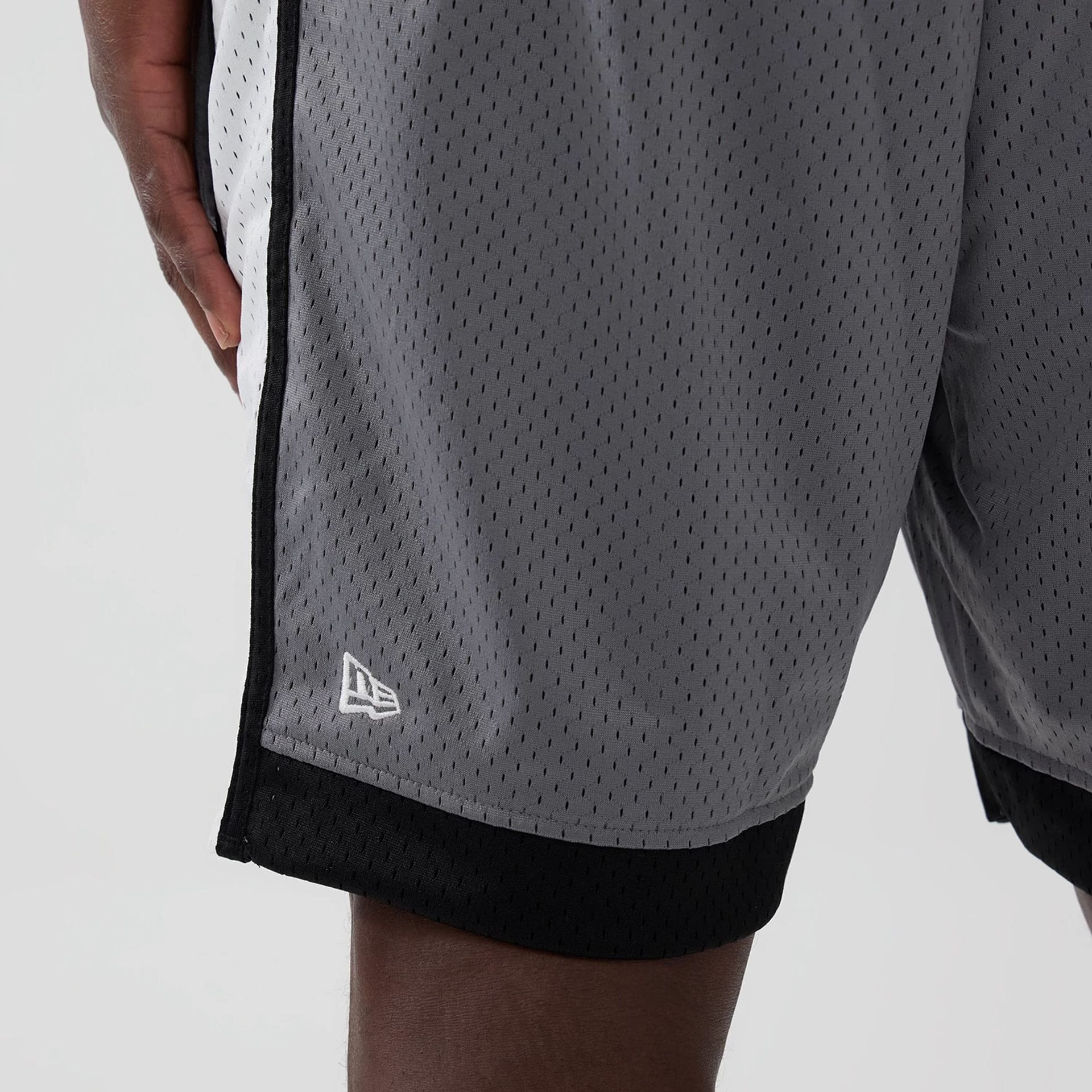 The model is wearing these NFL Las Vegas Raiders Mesh Shorts in grey. 4