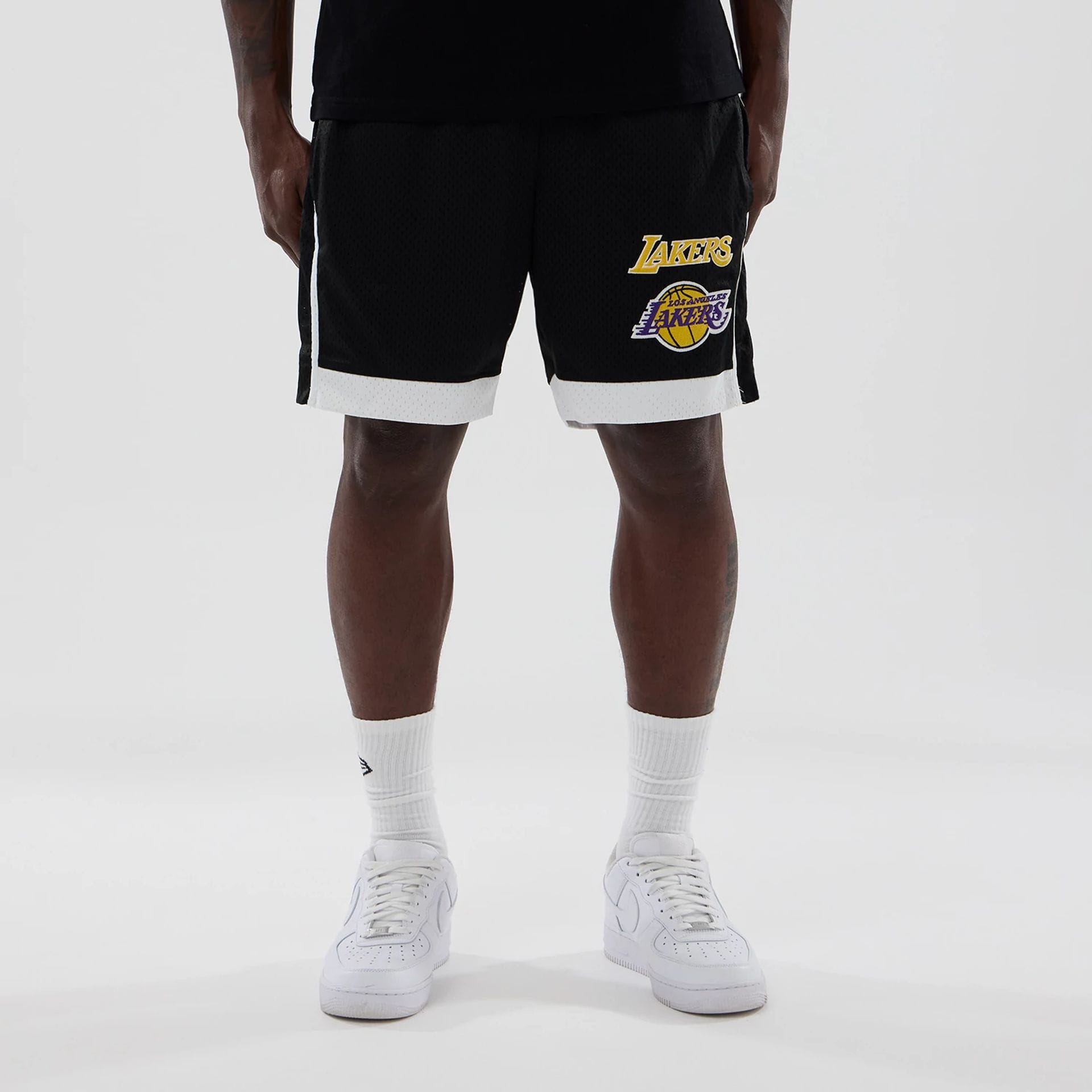 The model is wearing these NBA LA Lakers Mesh Shorts in black. 1