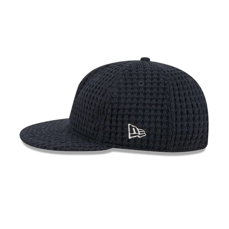 This is a  New Era Waffle Knit Navy Retro Crown 9FIFTY Adjustable Cap 6