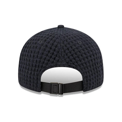 New Era Waffle Knit Navy Retro Crown 9FIFTY Adjustable Cap, rear view showing the textured waffle knit pattern on the navy crown and a black adjustable strap with a buckle closure at the back.