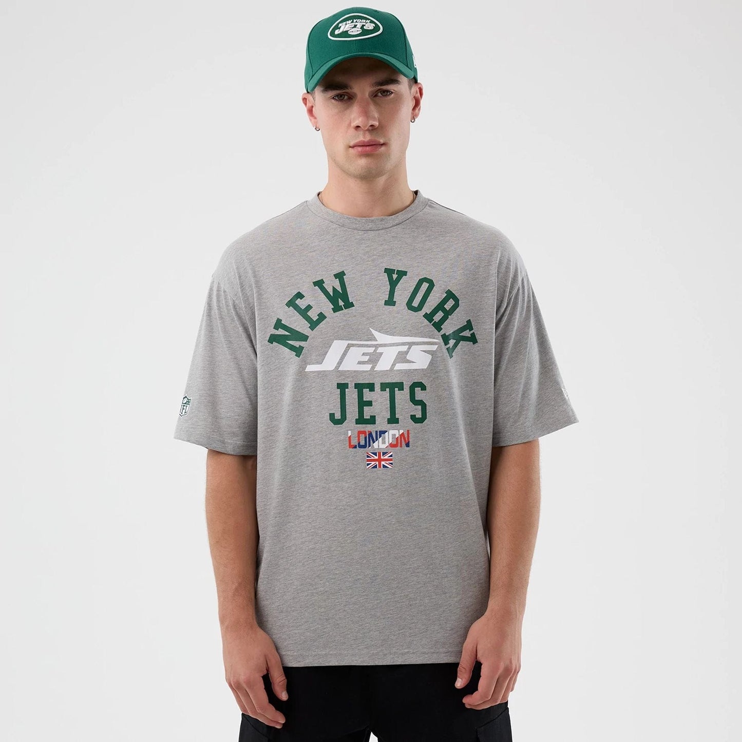 The Male model is wearing New York Jets NFL International Series Games Grey Oversized T-Shirt  1