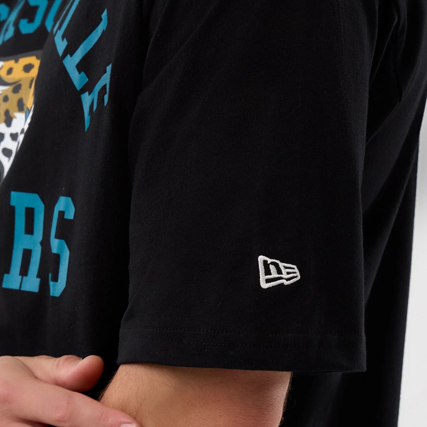 The Male model is wearing Jacksonville Jaguars NFL International Series Games Black Oversized T-Shirt  6