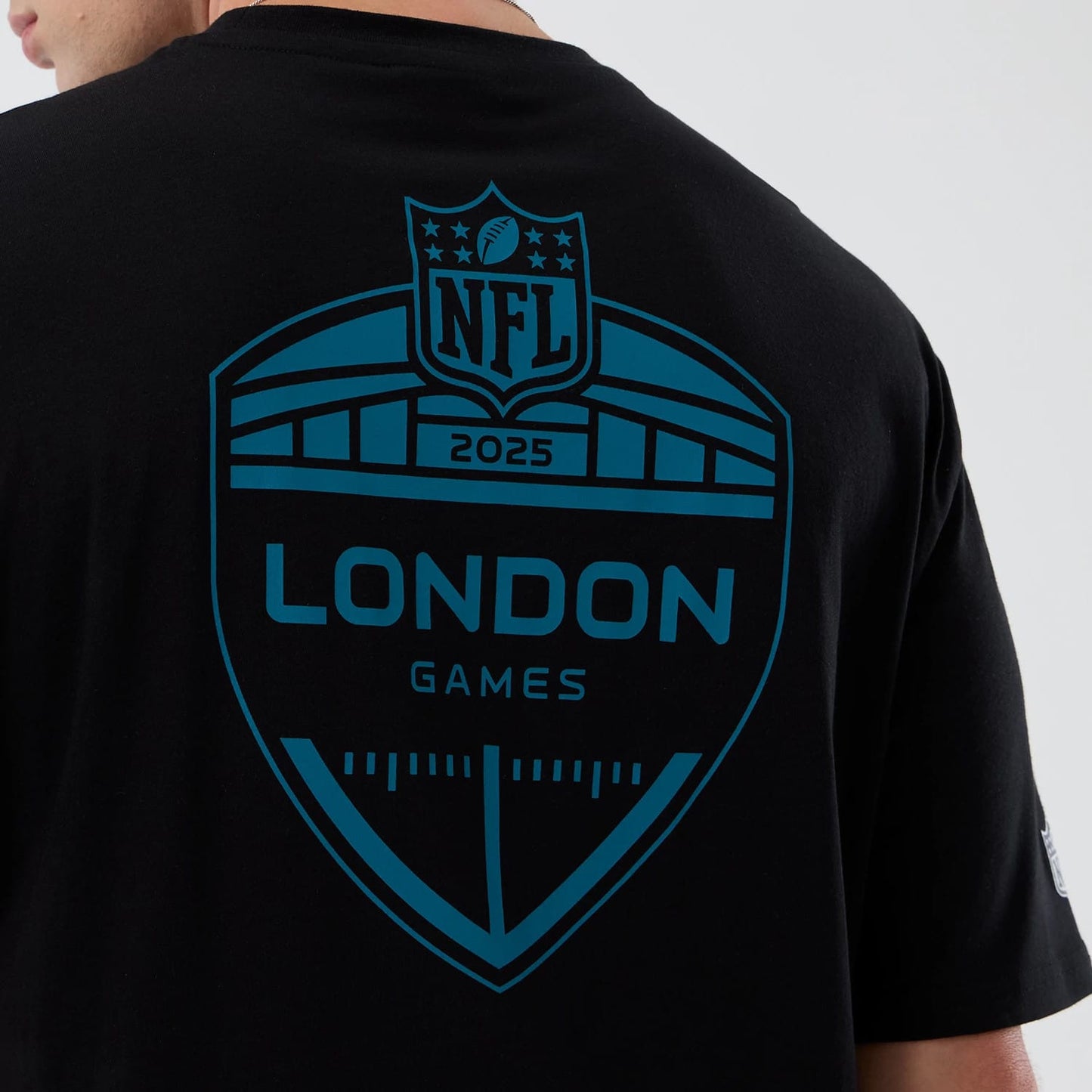 The Male model is wearing Jacksonville Jaguars NFL International Series Games Black Oversized T-Shirt 4