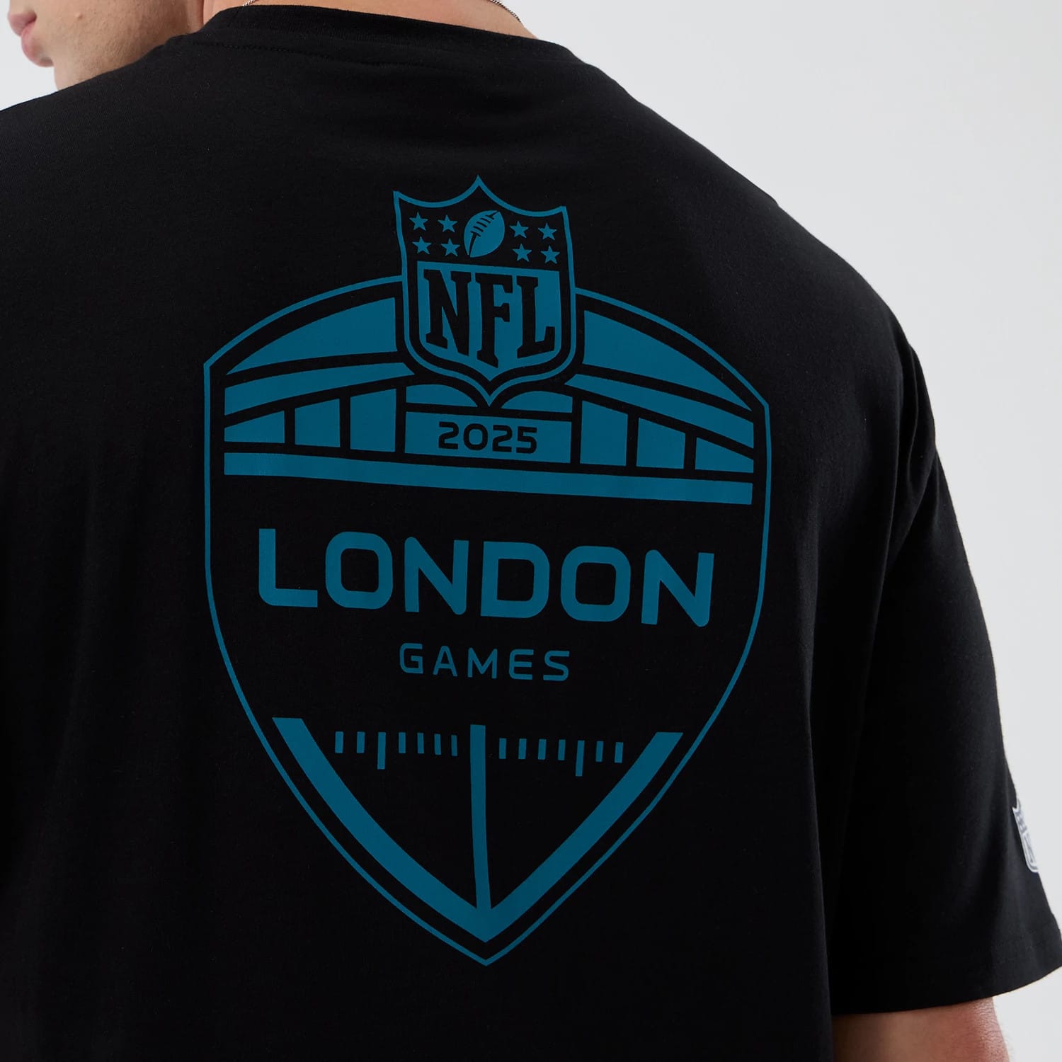 The Male model is wearing Jacksonville Jaguars NFL International Series Games Black Oversized T-Shirt 4