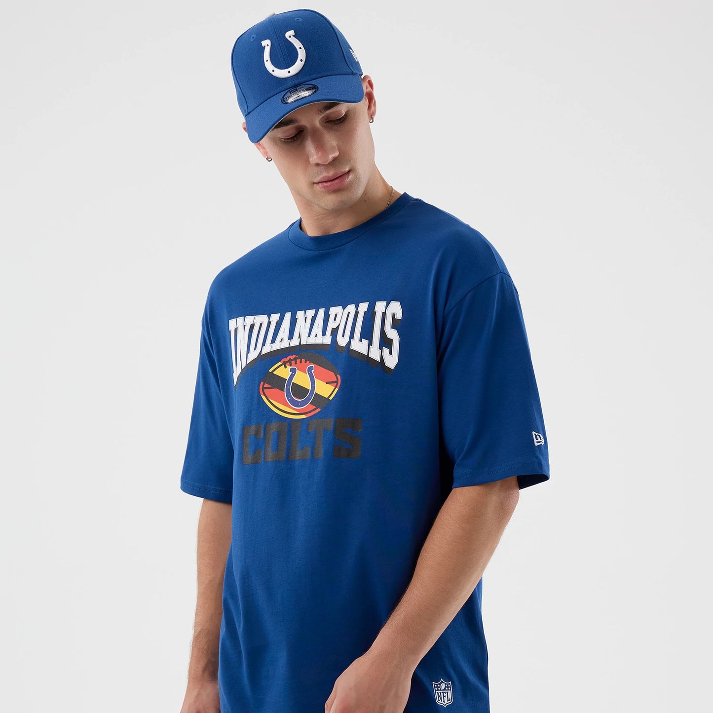 The Male model is wearing Indianapolis Colts NFL International Series Games Script Blue Oversized T-Shirt 7