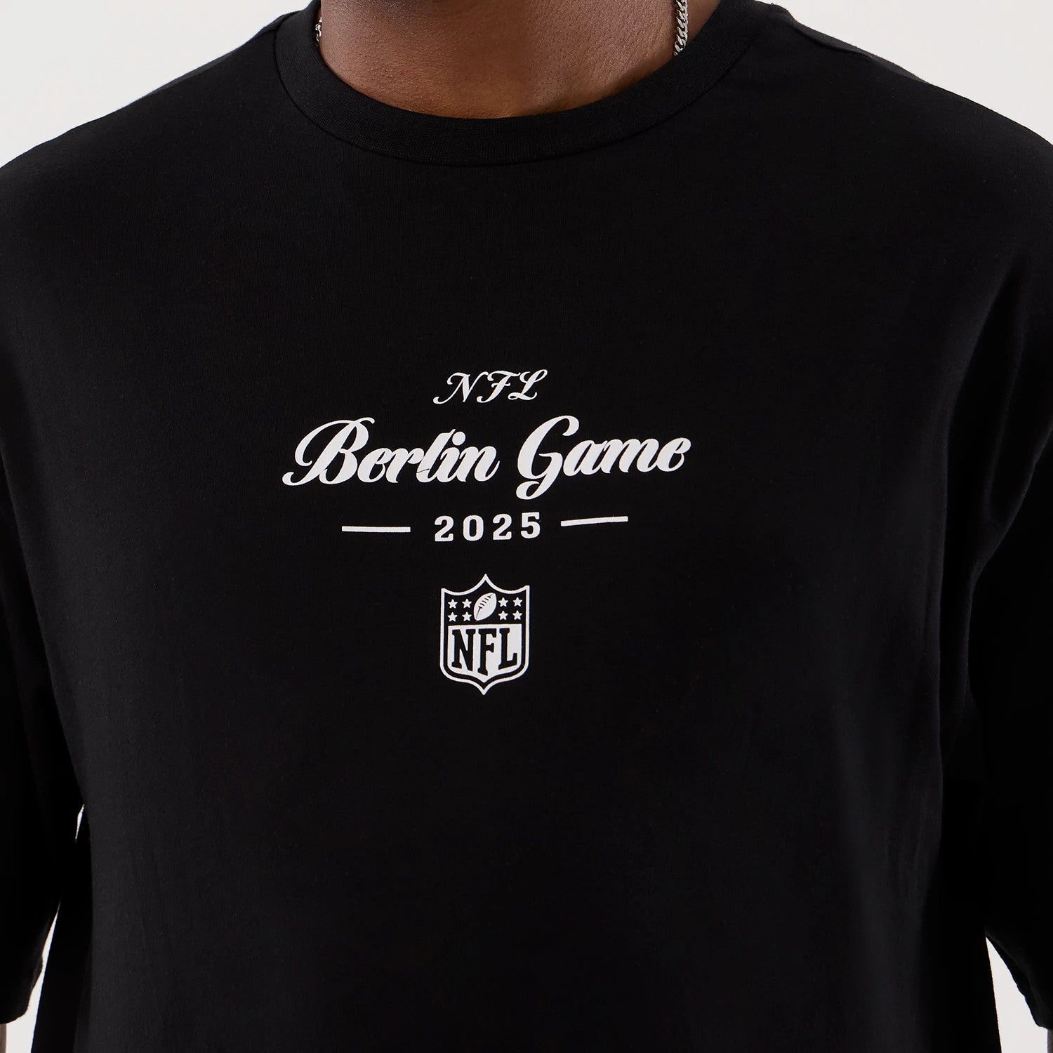 The Male model is wearing Berlin NFL International Series Games Black Oversized T-Shirt 3