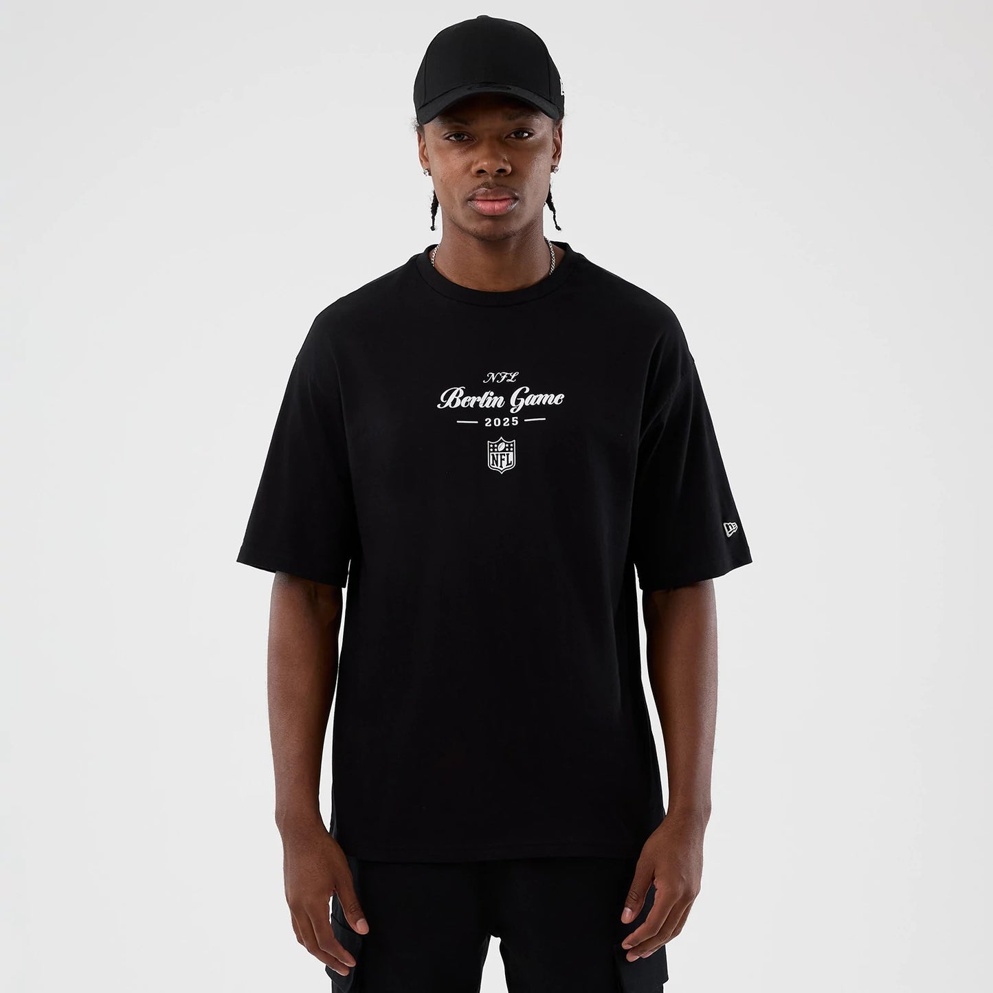 The Male model is wearing Berlin NFL International Series Games Black Oversized T-Shirt 1