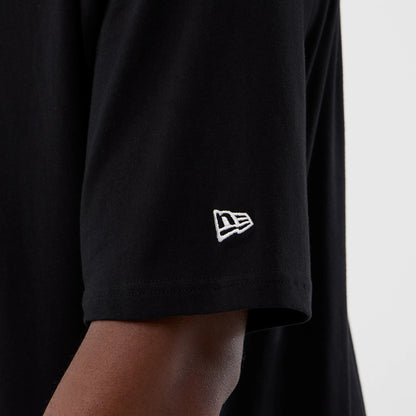 The Male model is wearing Berlin NFL International Series Games Black Oversized T-Shirt 4