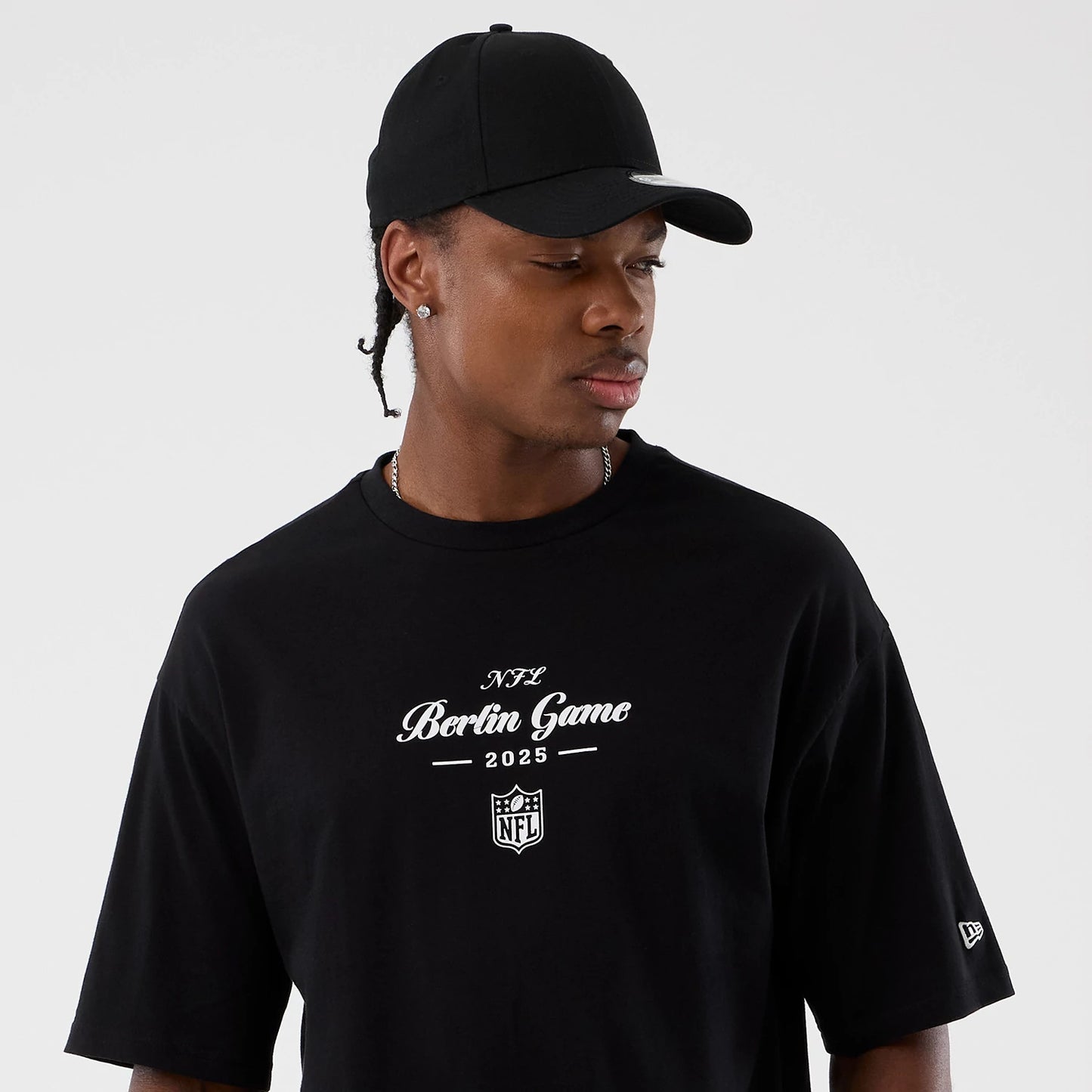 The Male model is wearing Berlin NFL International Series Games Black Oversized T-Shirt 6