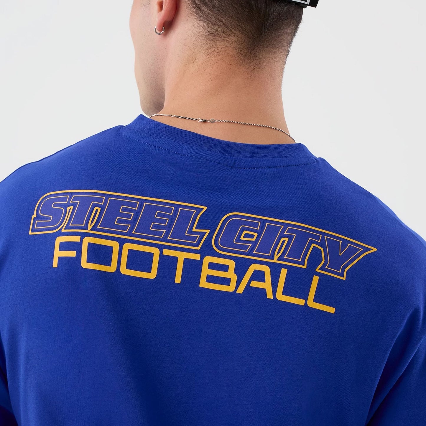 The Male model is wearing Pittsburgh Steelers NFL International Series Games Blue Oversized T-Shirt  6