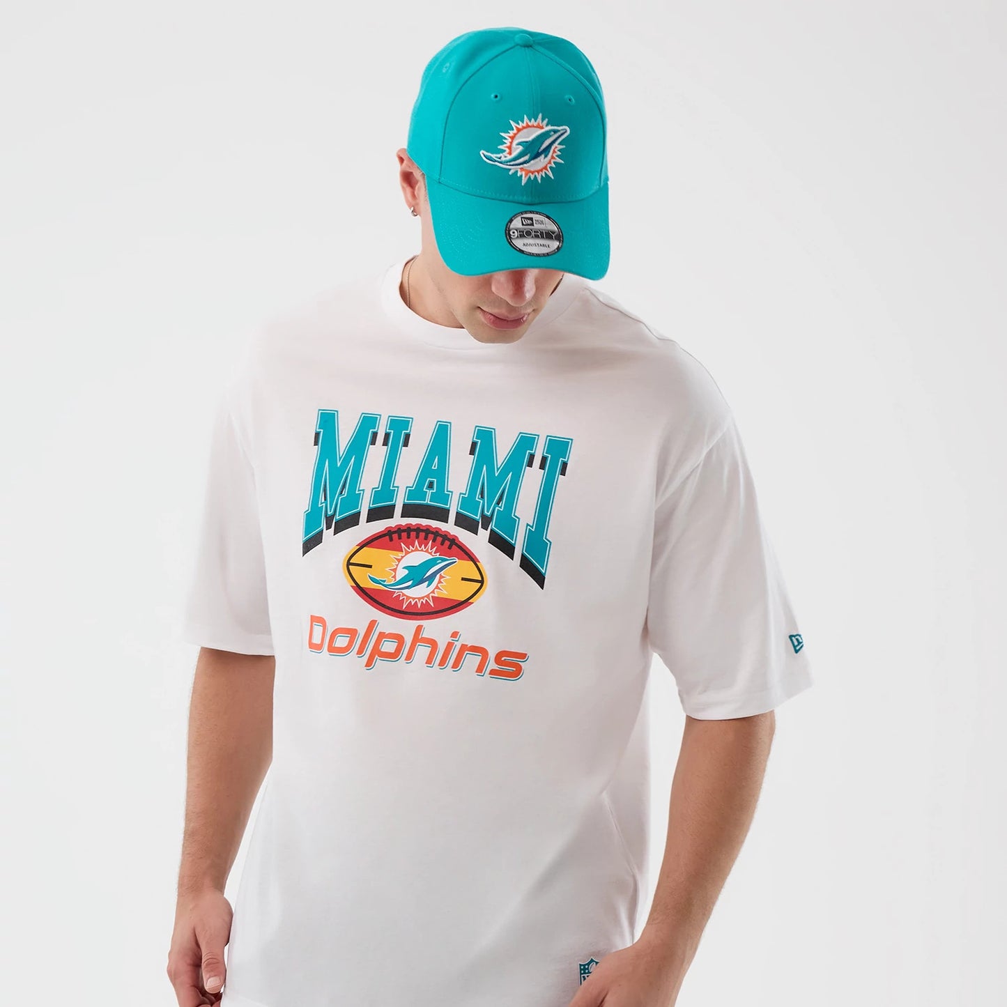 The Male model is wearing a Miami Dolphins NFL International Series Games Madrid White Oversized T-Shirt 3