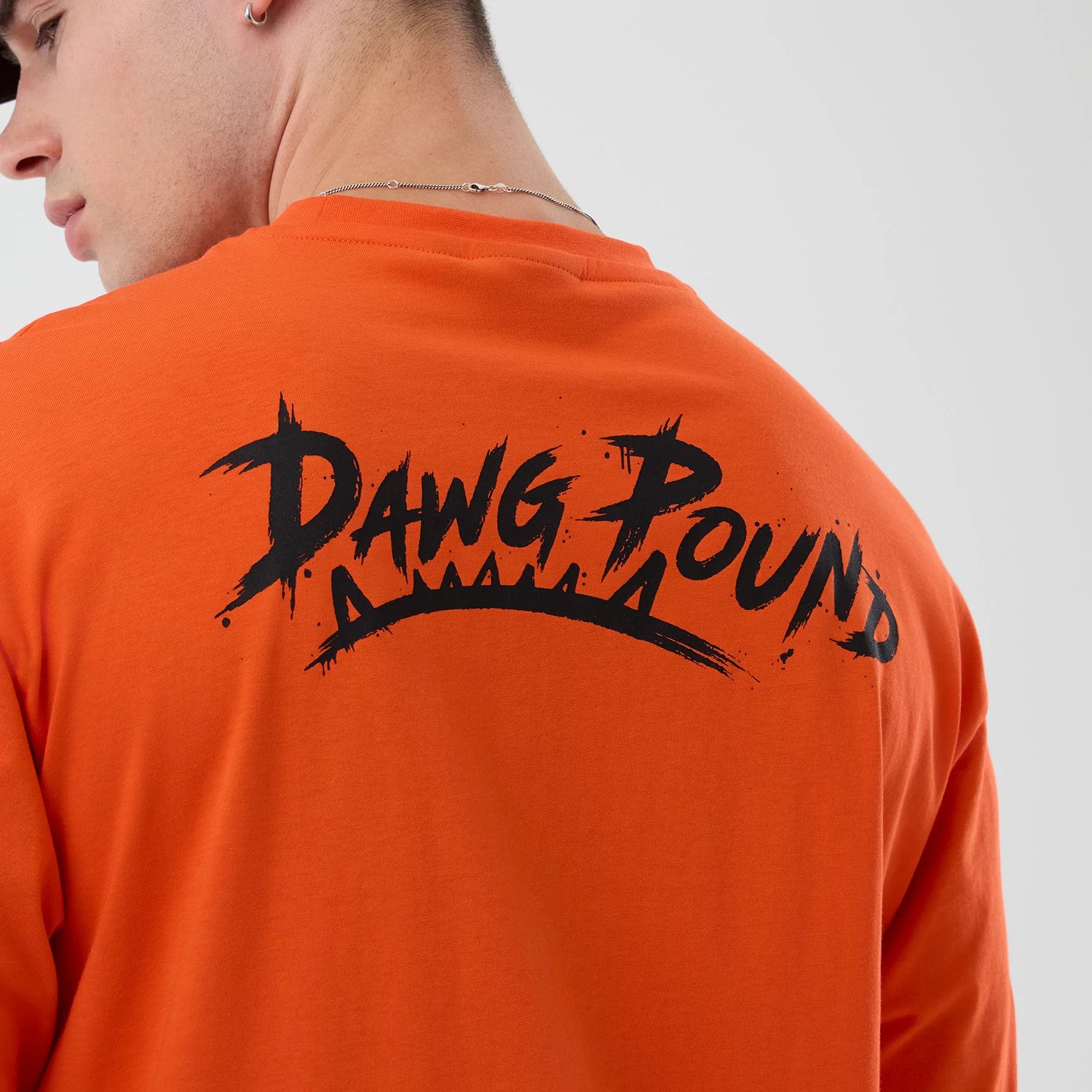 The Male model is wearing Cleveland Browns NFL International Series Games Orange Oversized T-Shirt 4
