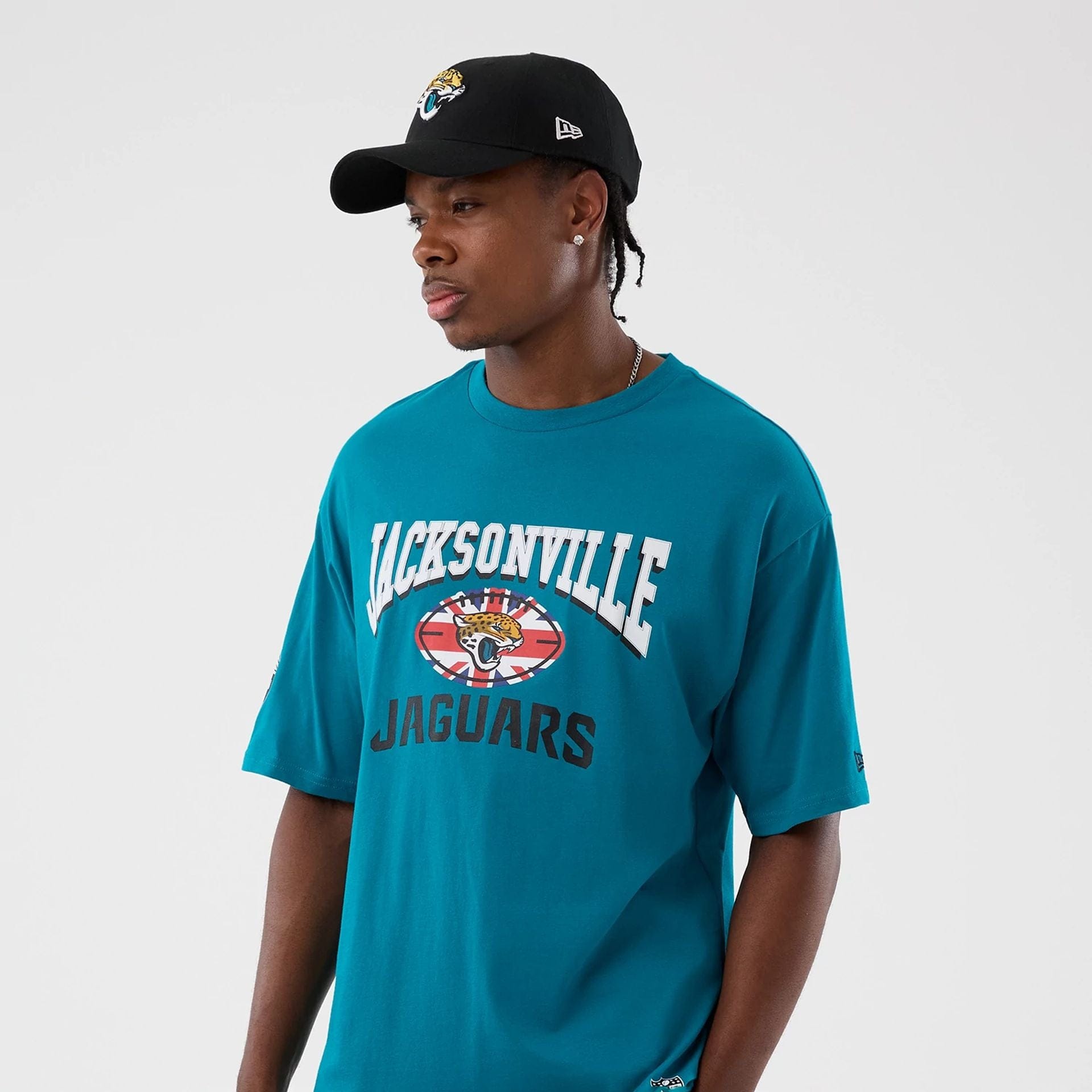 The Male model is wearing Jacksonville Jaguars NFL International Series Games Turquoise Oversized T-Shirt  7