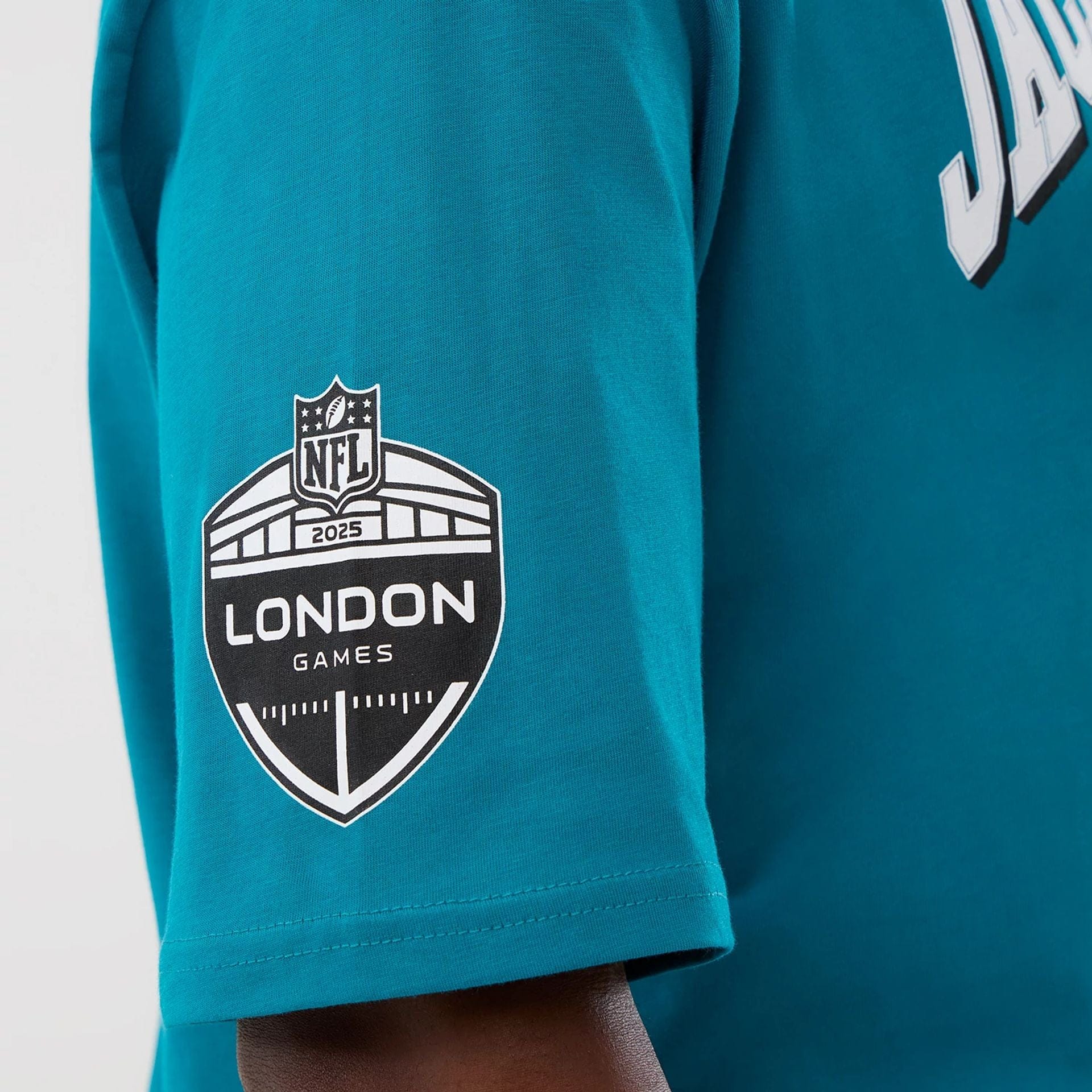 The Male model is wearing Jacksonville Jaguars NFL International Series Games Turquoise Oversized T-Shirt  3