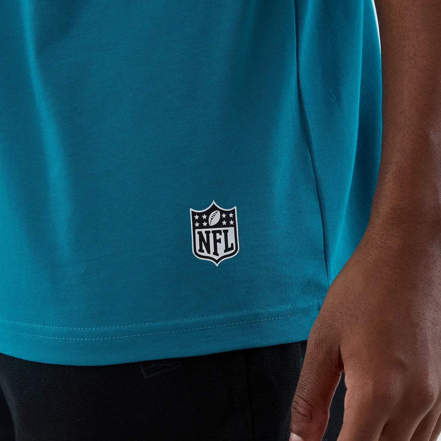 The Male model is wearing Jacksonville Jaguars NFL International Series Games Turquoise Oversized T-Shirt  5