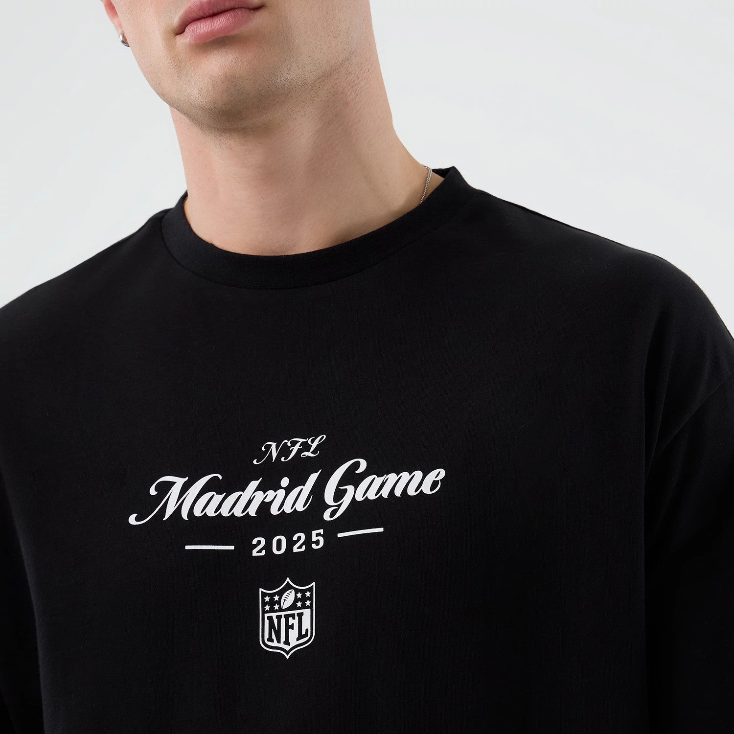 The Male model is wearing Madrid Game NFL International Series Games Black Oversized T-Shirt 3