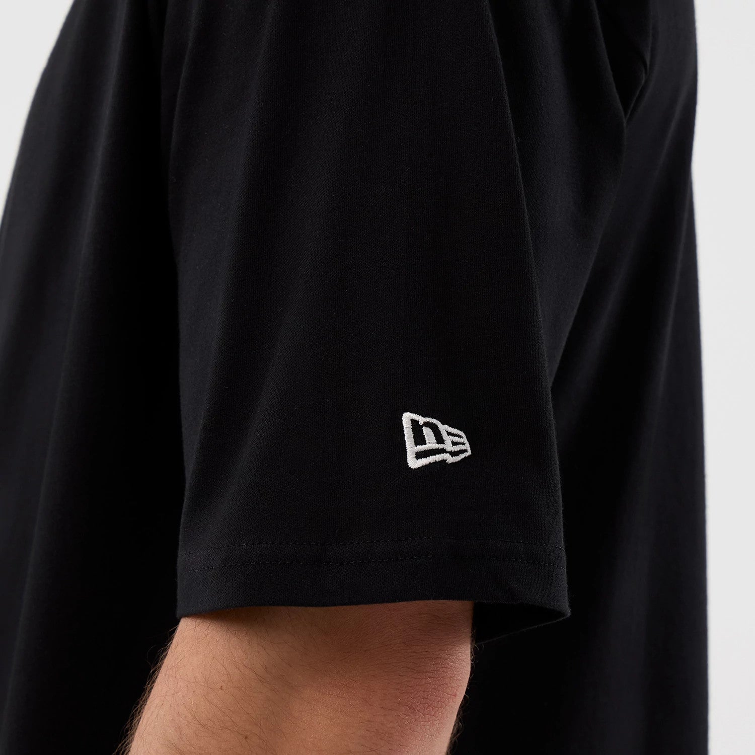 The Male model is wearing Madrid Game NFL International Series Games Black Oversized T-Shirt 5