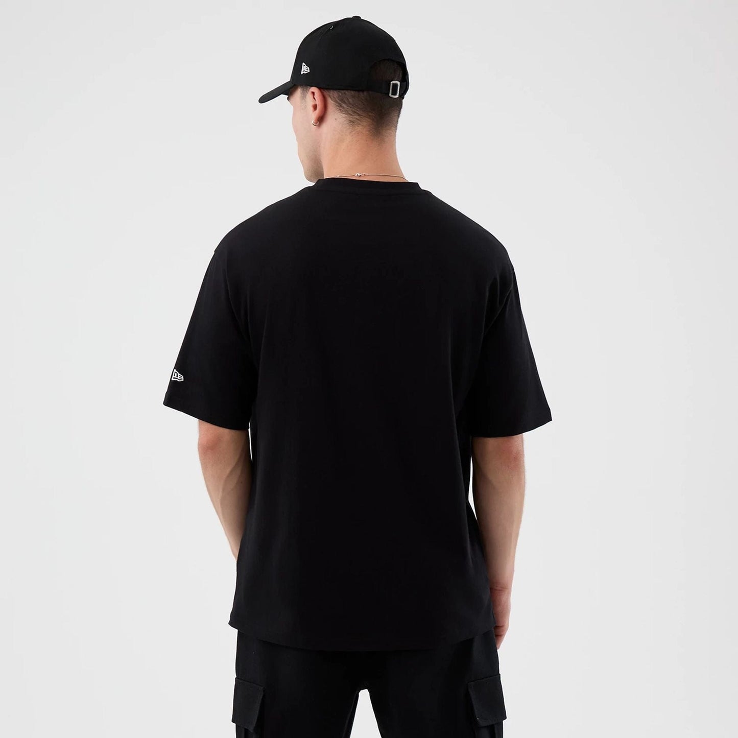 The Male model is wearing Madrid Game NFL International Series Games Black Oversized T-Shirt  2